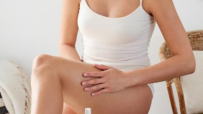woman massaging legs