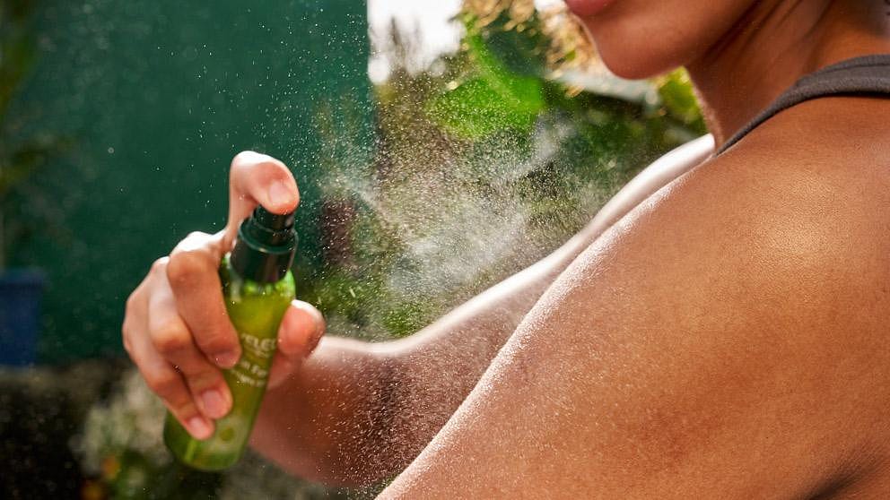 donna che applica l'olio spray